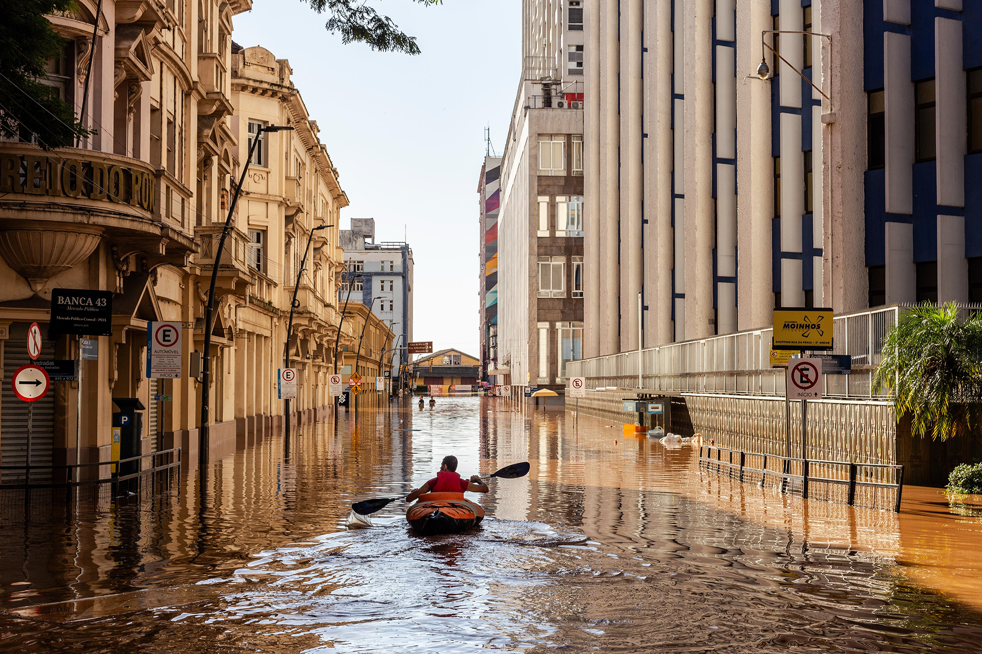 WINNER of SC Climate Award: a man rowing down a flooded street due to climate change