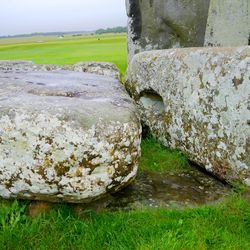 The Altar Stone, seen underneath two bigger Sarsen stones.