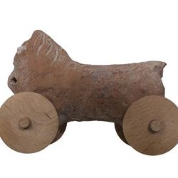 Ancient Clay Horse toy with wheels on white background