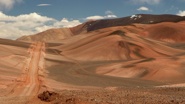 A dirt road high in the Andes mountains. Traveling along the route across the arid desert dunes and mountain range.