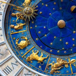 Astrological signs on ancient clock Torre dell'Orologio, Venice, Italy. Medieval Zodiac wheel and constellations. Golden symbols on star circle. Concept of astrology, horoscope and time.