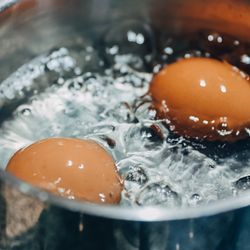 Saucepan with boiling eggs on a gas stove