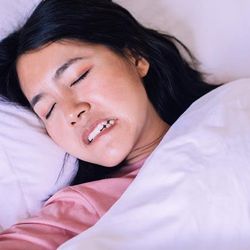 Woman with bruxism grinding teeth in her sleep