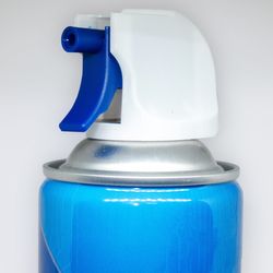 close up of nozzle of a blue can of compressed air