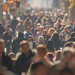 Crowd of people walking city street