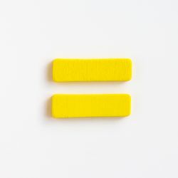 yellow painted wooden equals sign on white background