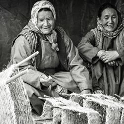 Old Tibetan women selling wicker baskets on the market in Leh, India.