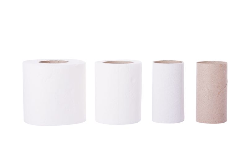 four toilet paper tubes on a white background, going from full on the left to empty tube on the right