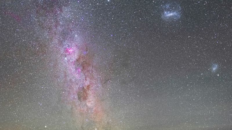 the band of the Milky Way and the Magellanic clouds are visible in the photo. The whole sky is filled with stars but these three structures are clearly visible