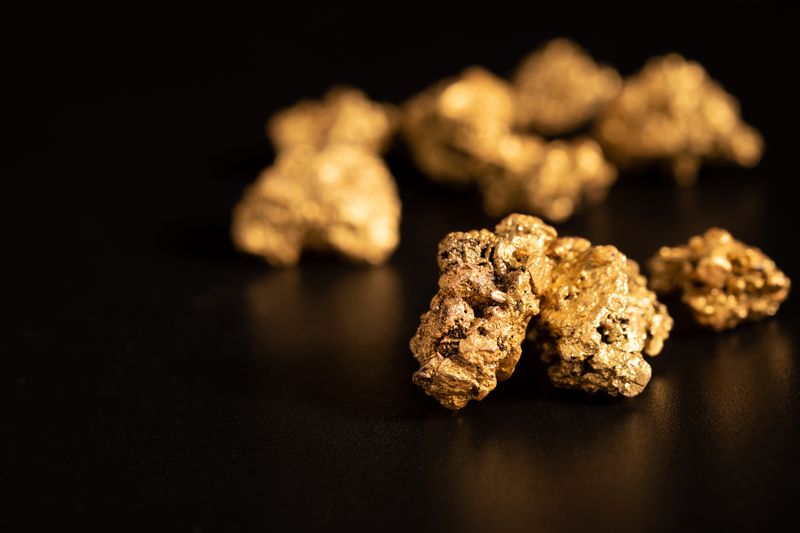 Gold nuggets on black background