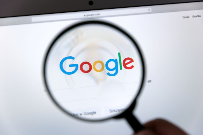 A magnifying glass on a computer screen showing Google.