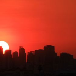 The skyline of a city as the Sun sets make the sky in the summer