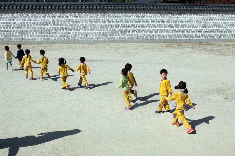 A group of kids take a tour of the Gyeongbokgung Palace complex in Seoul, South Korea,