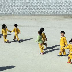 A group of kids take a tour of the Gyeongbokgung Palace complex in Seoul, South Korea,