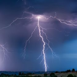 Lightning strikes the ground in a summer storm all over the sky in southern France.