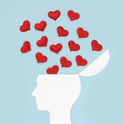 white silhouette of human with head hinged open and red hearts flowing out and upwards, on light blue background