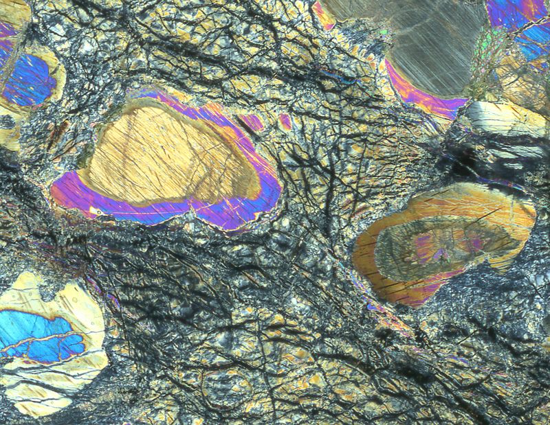  Mantle rock recovered during the project viewed down a petrographic microscope, revealing a history of both mantle melting and seawater-rock interaction.