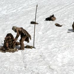 Prehistoric caveman Neanderthals on a snow Ice Age background