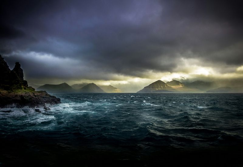 Gloomy scene of crashing waves on rocky islands