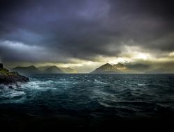 Gloomy scene of crashing waves on rocky islands