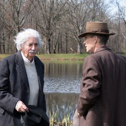 Tom Conti as Albert Einstein and Cillian Murphy as J. Robert Oppenheimer in OPPENHEIMER, written, produced, and directed by Christopher Nolan. 