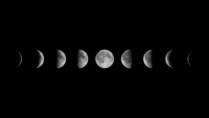 9 images of the moon are visible in the photo from a waxing crescent on the right slowly growing into a full moon in the middle before diminishing back into a crescent, pointing in the other direction