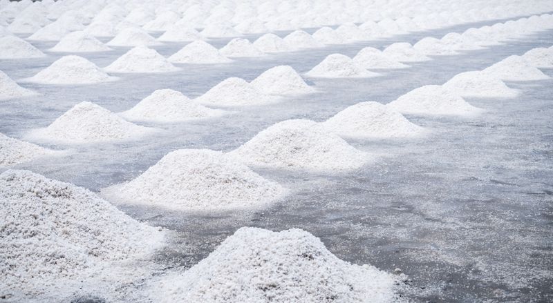 Piles of white sea salt on a grey floor