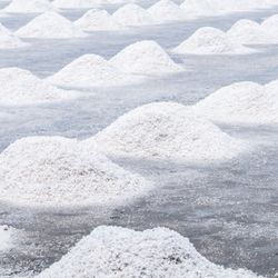 Piles of white sea salt on a grey floor