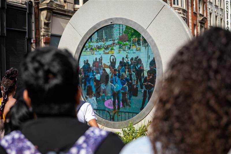 Dublin, Ireland - May 22 2024 Crowds gather on North Earl Street to wave at the newly installed Dublin - New York portal art installation, that sees a real time stream between the two countries