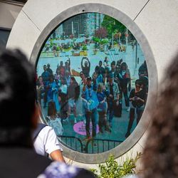 Dublin, Ireland - May 22 2024 Crowds gather on North Earl Street to wave at the newly installed Dublin - New York portal art installation, that sees a real time stream between the two countries