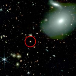 The image shows counteless galaxies including a bit one in the forground. A red circle highight a bright spot of light - that's the quasar with no neighbors