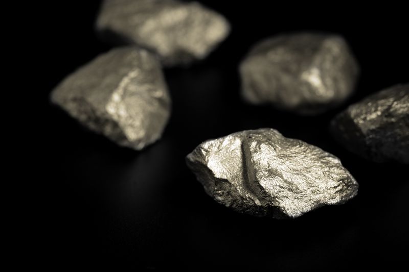 nuggets of a rare-earth metals. They are shiny and silvery with a rough surface