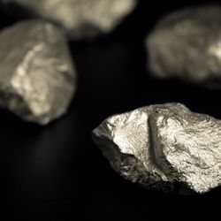 nuggets of a rare-earth metals. They are shiny and silvery with a rough surface