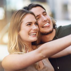 couple taking a selfie with a tablet