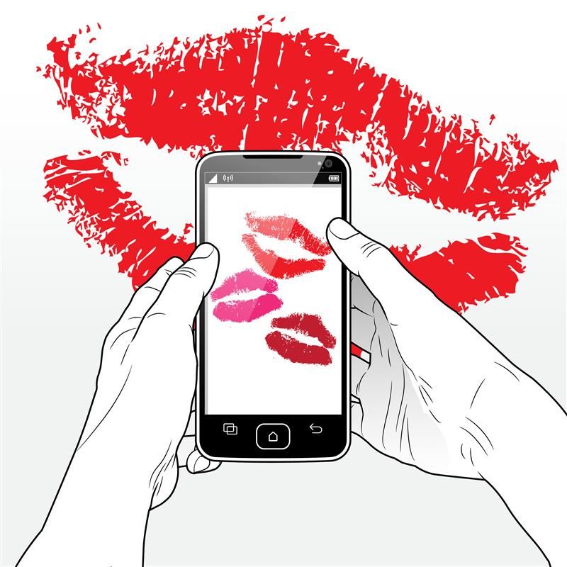 A digital illustration showing a pair of hands holding a smart phone. The hands are colourless, and indicated by a line drawing while the phone is black. The phone screen is white and shows three lipstick kiss images on it. In the background, there is a larger pair of lipstick marks. 