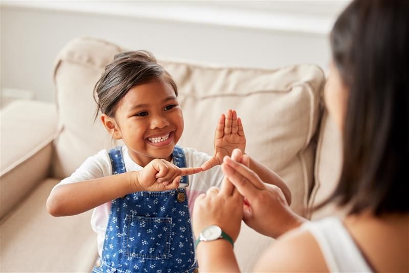 A deaf child speaking in sign language