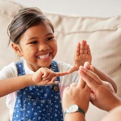 A deaf child speaking in sign language