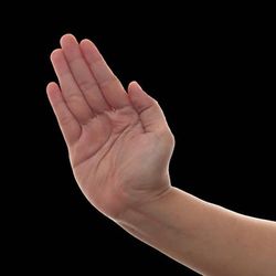 A photo of a hand preparing to make the slap action. The hand is set against a black background.