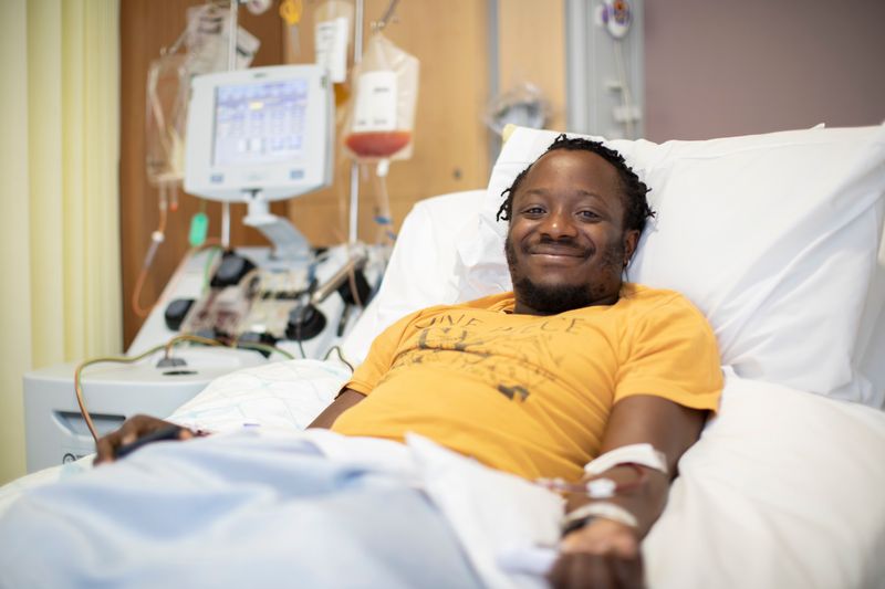 Man laying in a hospital bed donating stem cells