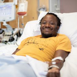 Man laying in a hospital bed donating stem cells