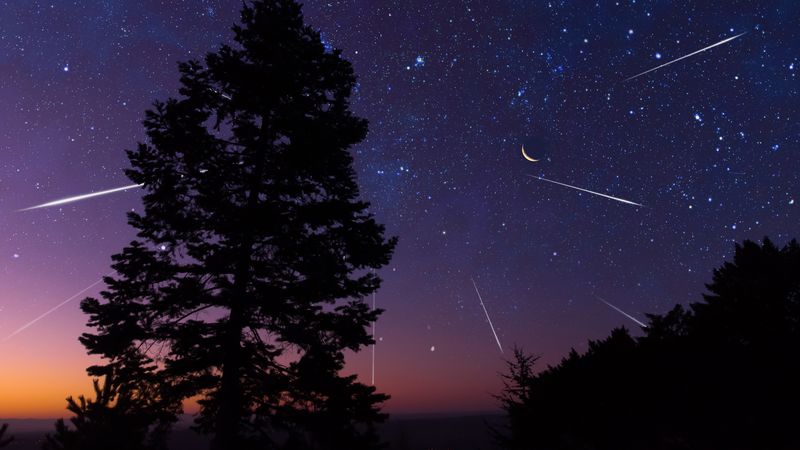 Starry Milky Way skies with comet and meteor shower, falling and shooting stars.