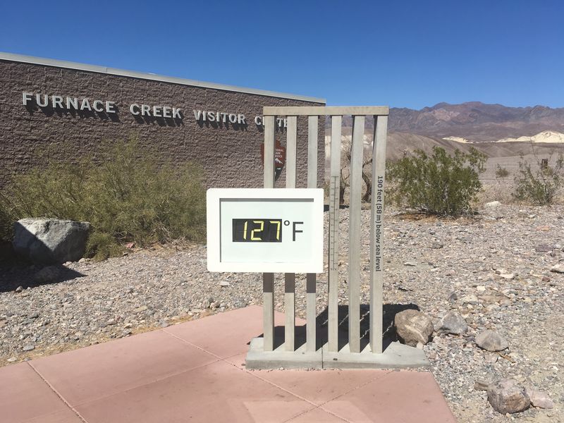 digital thermometer outside Furnace Creek Visitor Center, showing a temperature of 127 degrees Fahrenheit