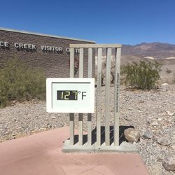 digital thermometer outside Furnace Creek Visitor Center, showing a temperature of 127 degrees Fahrenheit