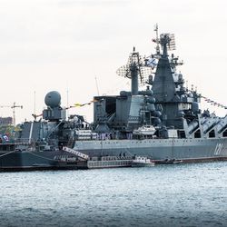 A photo of the Moskva warship in port in 2021. The ship can be seen afloat with flags raised. 