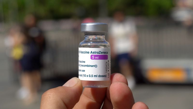 close up of someone holding a vial of the AstraZeneca covid-19 vaccine