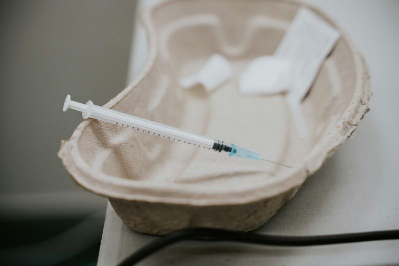 syringe in a paper kidney dish