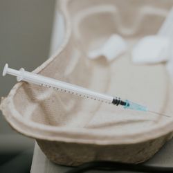 syringe in a paper kidney dish