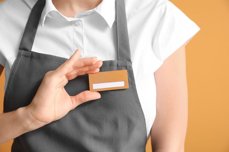 Waiter wearing an apron and a blank name tag