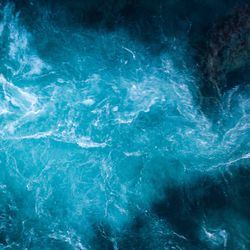 Aerial view of Atlantic ocean waves washing black basaltic sand beach in Iceland