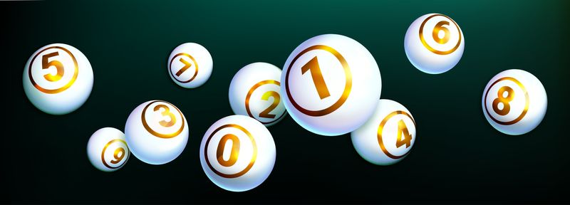 White shiny balls with golden text of numbers isolated on dark background